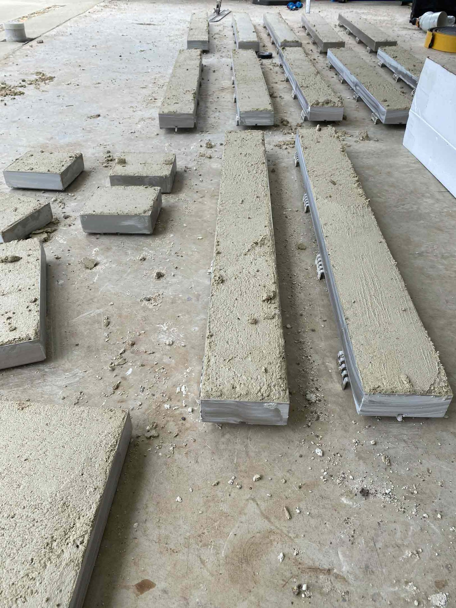 HIDE Concrete Linear Strip Drain Covers with concrete infill drying waiting to be honed and installed.