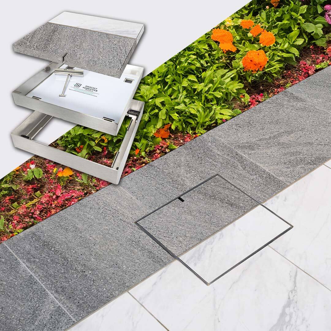 HIDE stainless steel Access Cover with dual white and grey tile inlay installed next to backyard garden