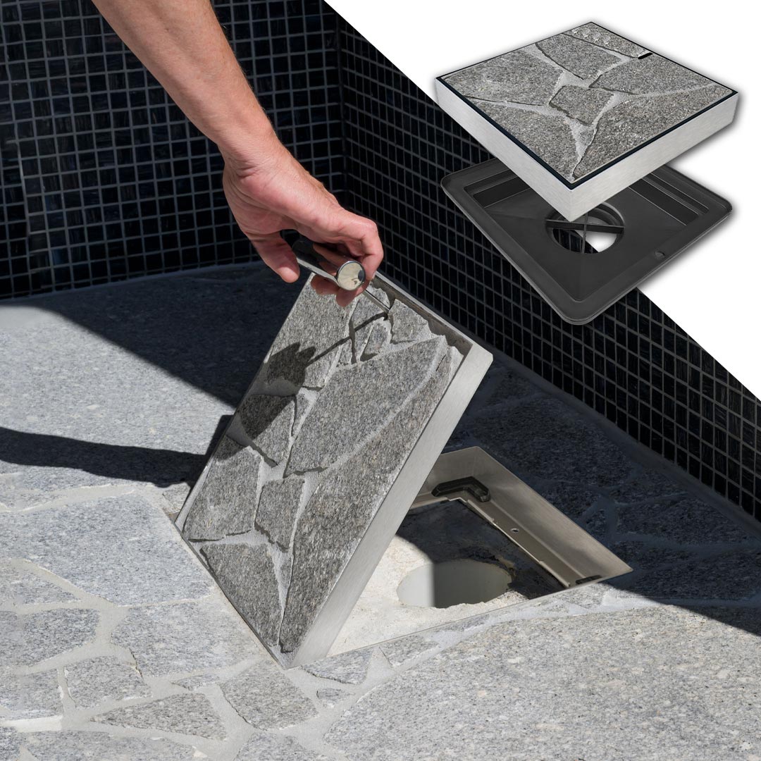 HIDE Drain Cover with grey crazy pave inlay being lifted up to view drainage pipe below.