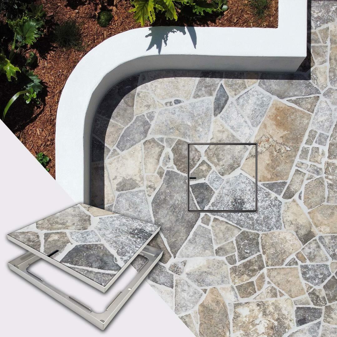 HIDE 656mm Drain Cover with crazy pave tile inlay installed next to garden bed.