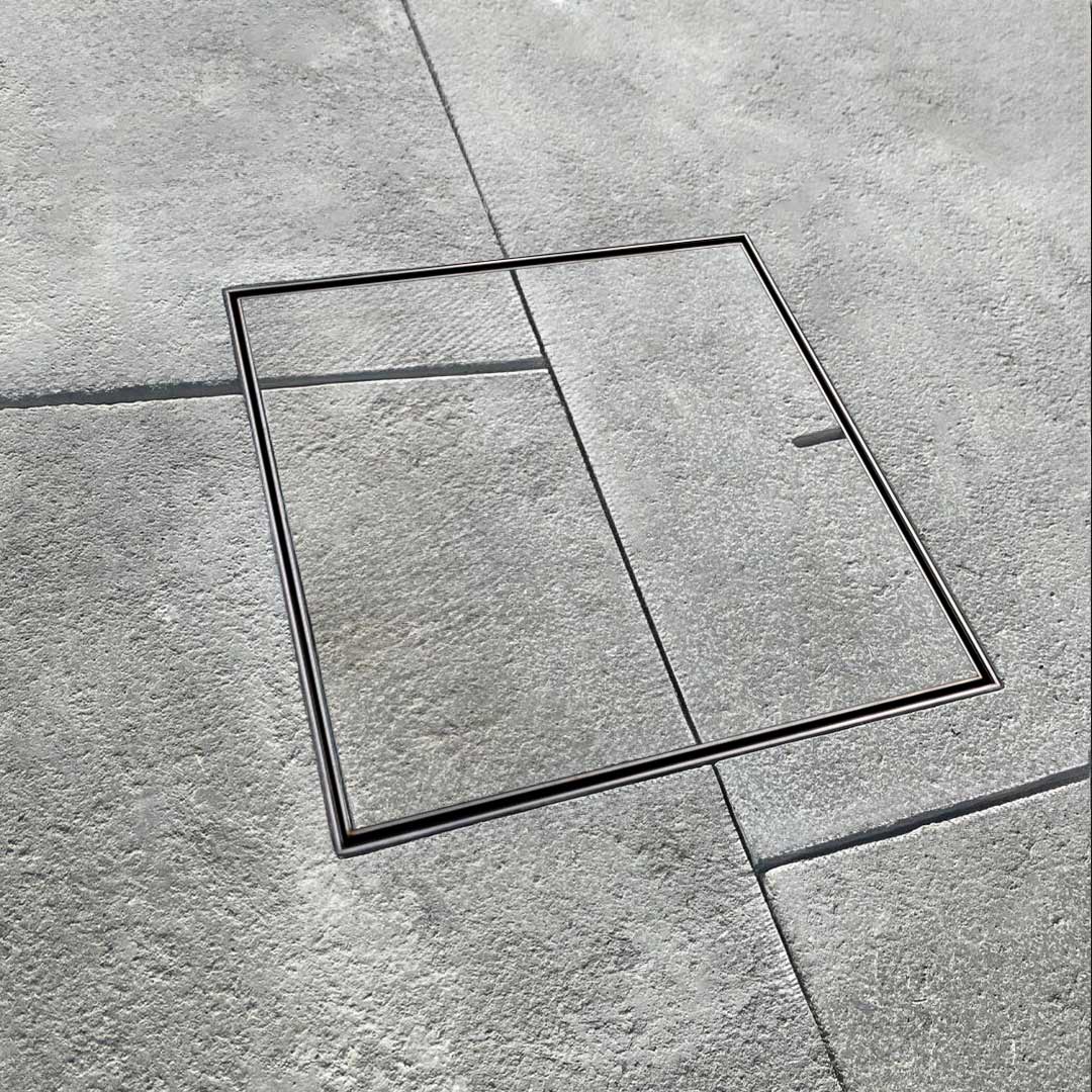 HIDE Drain Cover with paving pattern running seamlessly through the cover to create a completely aesthetic landscape