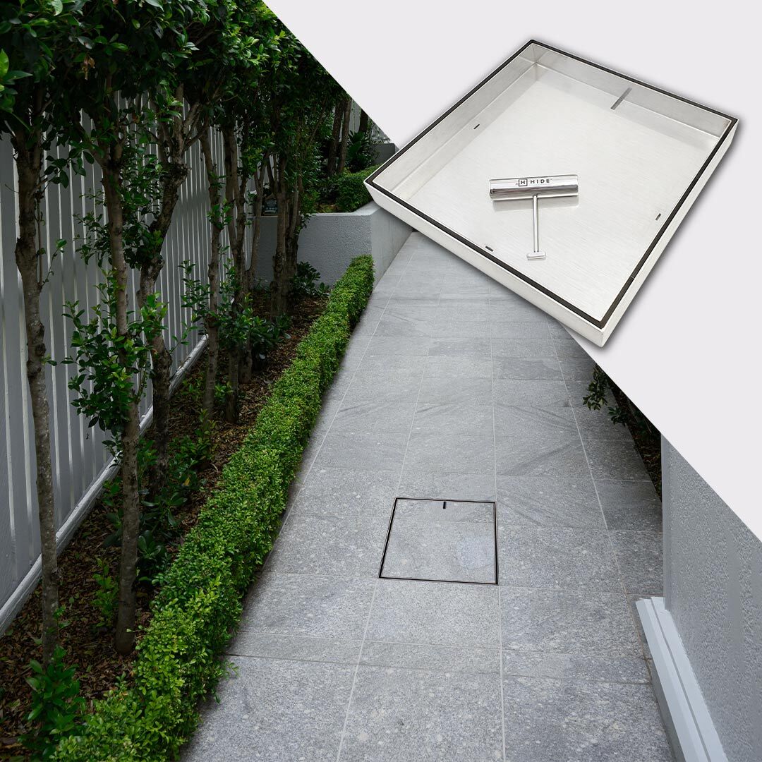 HIDE Drain Cover with grey tile inlay installed along house walkway.