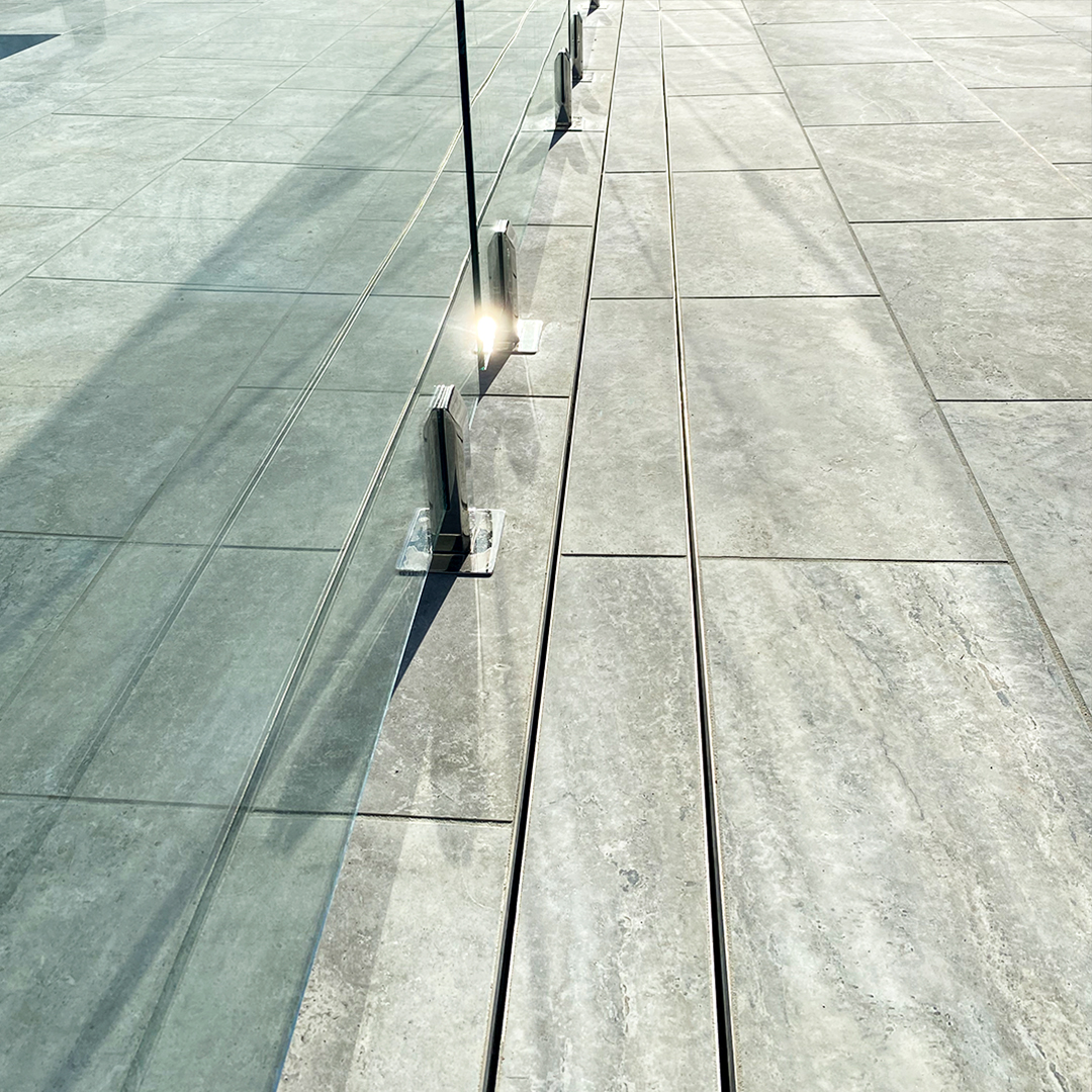 Linear-drain---beside-glass-