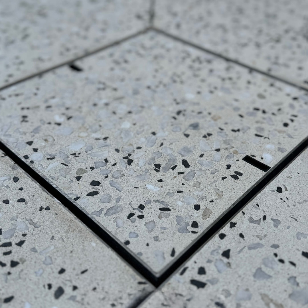 Concrete Drain Cover with exposed honed aggregate concrete inlay.